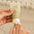 Close-up of Tropic Hydrating Cleanser being dispensed onto a hand, showing the refreshing facial gelée with organic aloe vera, cucamelon, and hyaluronic acid.